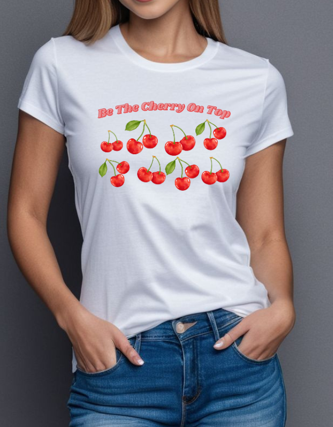 Person wearing a white t-shirt with cherry design and text against a gray background