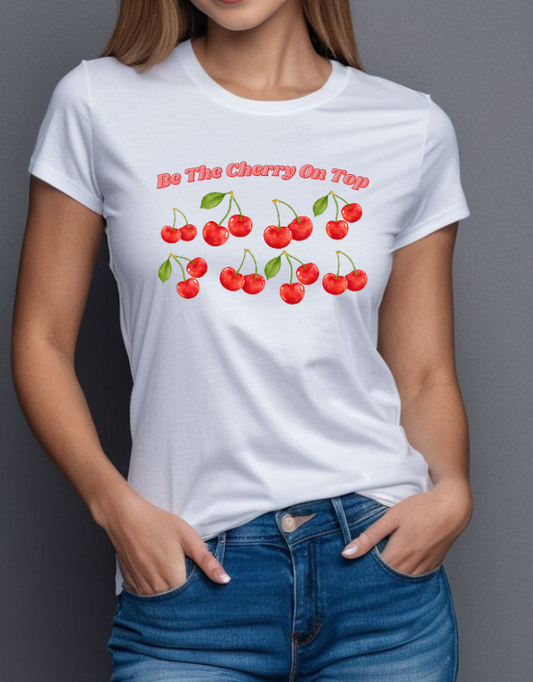 Person wearing a white t-shirt with cherry design and text against a gray background